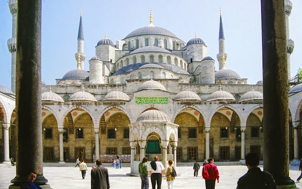 Blue Mosque courtyard with visitors, Istanbul, part of guided tour and skip-the-line tickets combo.