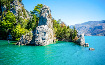 Emerald water reservoir at Green Canyon, rocky cliffs and trees, Oymapinar Dam, Manavgat, Turkey.