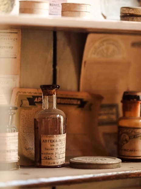 Vintage medicine bottles on display at New Orleans Pharmacy during Haunted Ghost, Voodoo & Vampire Tour.