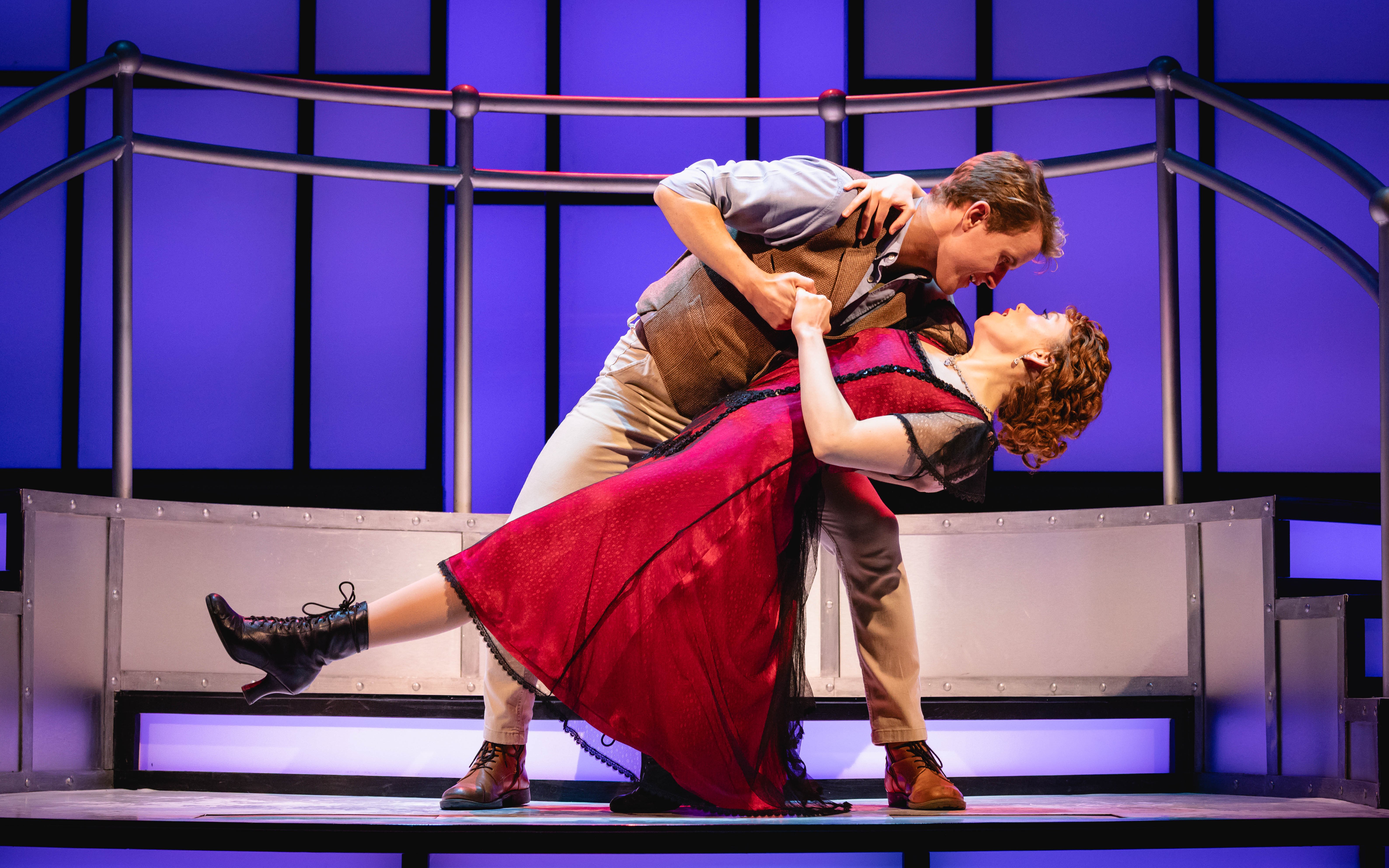 Stage performance of Titanique Westend with actors in a dramatic dance pose.