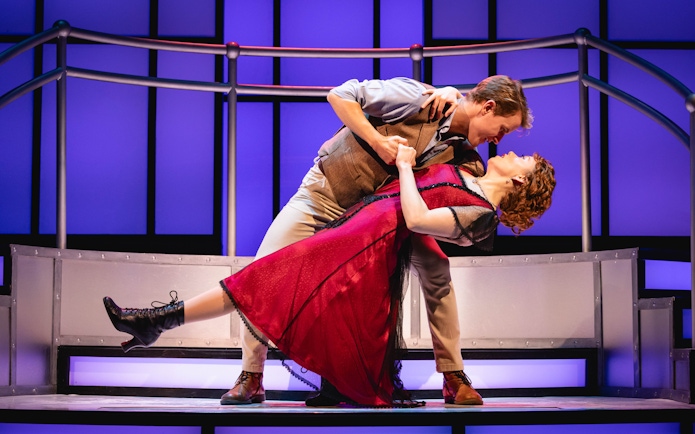Stage performance of Titanique Westend with actors in a dramatic dance pose.