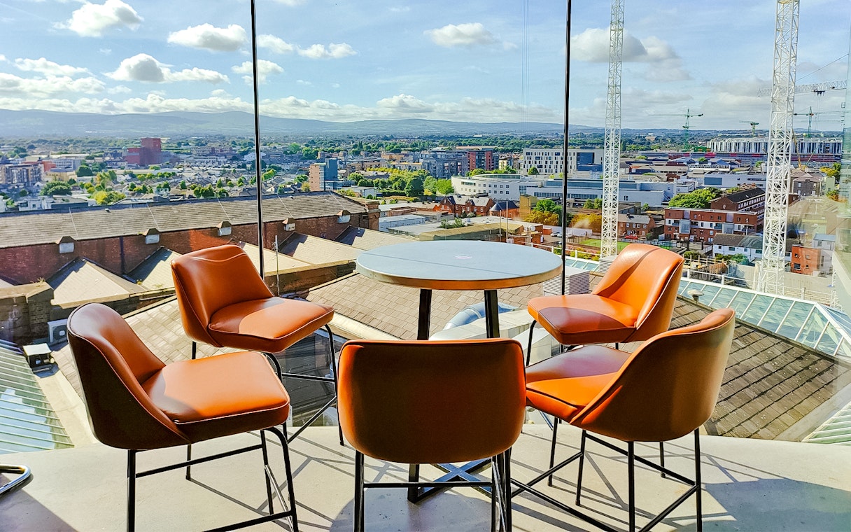 Gravity Bar at Guinness Storehouse with panoramic view of Dublin cityscape.