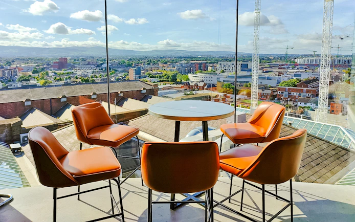 Gravity Bar at Guinness Storehouse with panoramic view of Dublin cityscape.