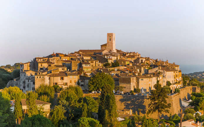 Saint Paul de Vence village with stone buildings and church tower in Provence, France.