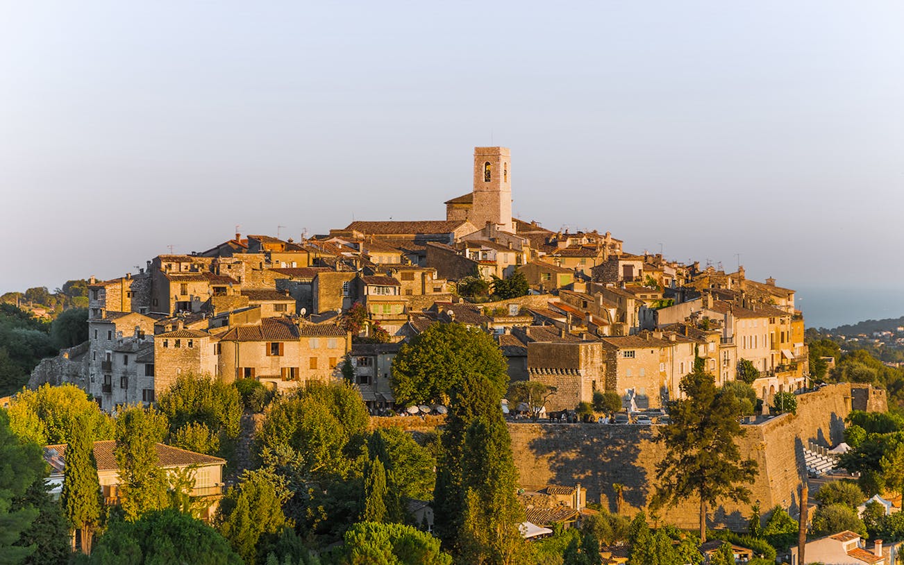 Saint Paul de Vence village with stone buildings and church tower in Provence, France.