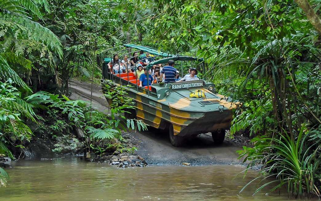 Tourists on an Army Duck vehicle exploring Kuranda rainforest, Queensland.