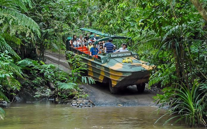 Tourists on an Army Duck vehicle exploring Kuranda rainforest, Queensland.