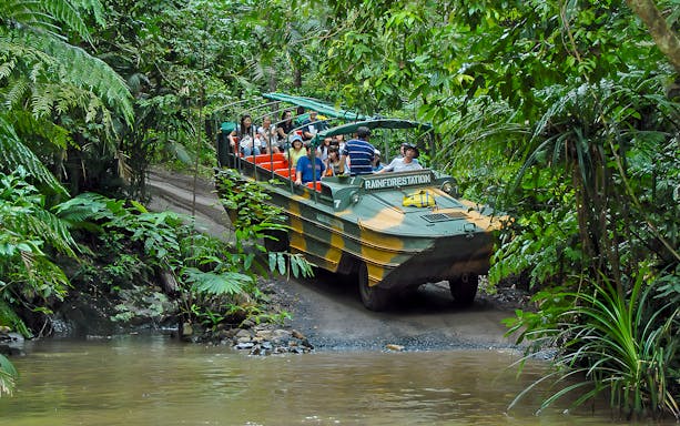 Tourists on an Army Duck vehicle exploring Kuranda rainforest, Queensland.