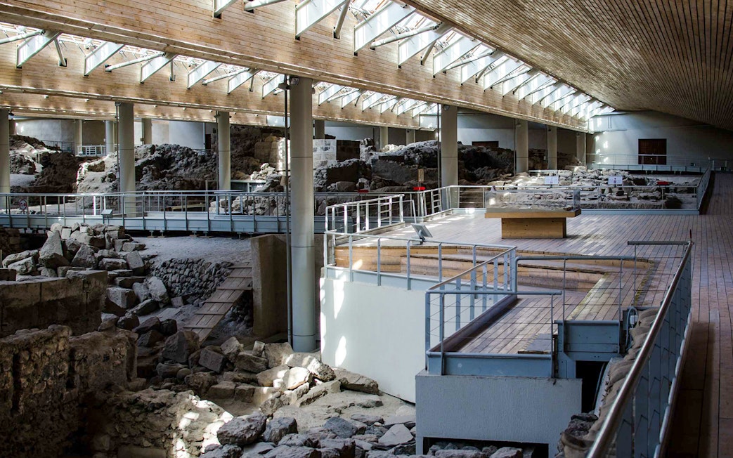 Akrotiri Archaeological Site interior with ancient ruins and walkways in Santorini, Greece.