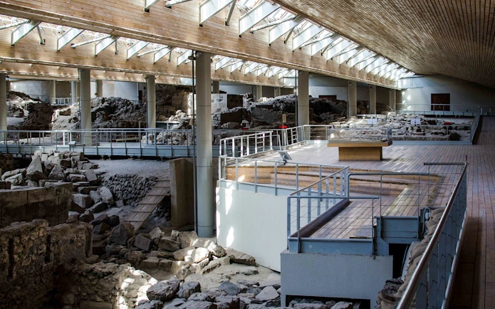 Akrotiri Archaeological Site interior with ancient ruins and walkways in Santorini, Greece.