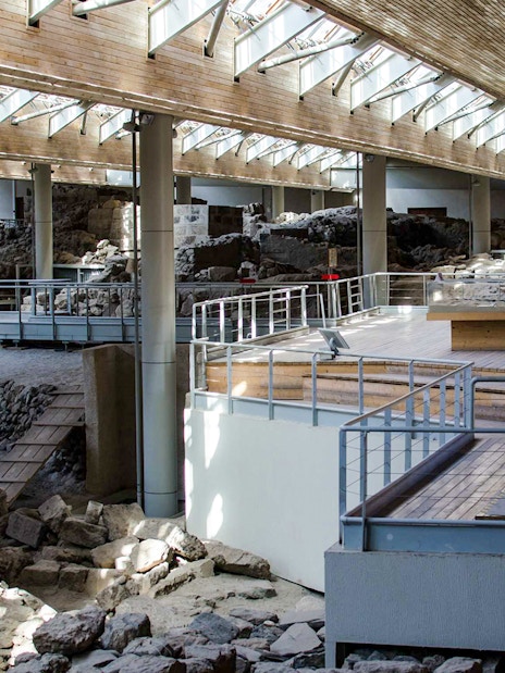 Akrotiri Archaeological Site interior with ancient ruins and walkways in Santorini, Greece.