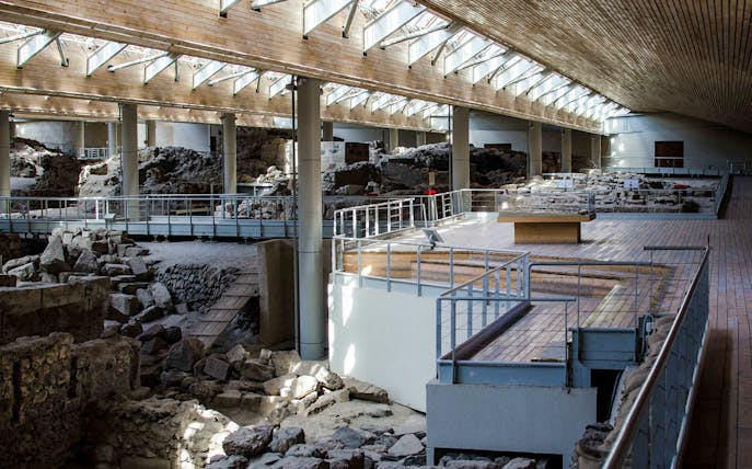 Akrotiri Archaeological Site interior with ancient ruins and walkways in Santorini, Greece.