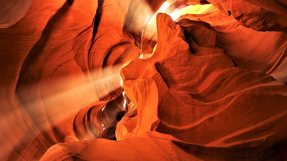 Lower Antelope Canyon's sandstone formations with sunlight beams, part of Las Vegas tour.