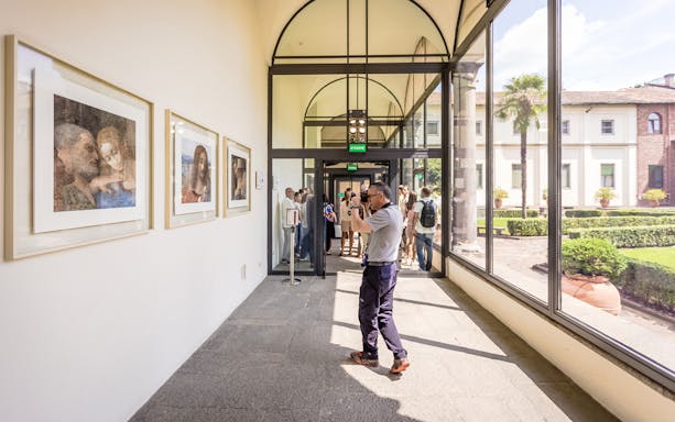 Tourists photographing art near The Last Supper in Milan, Italy.