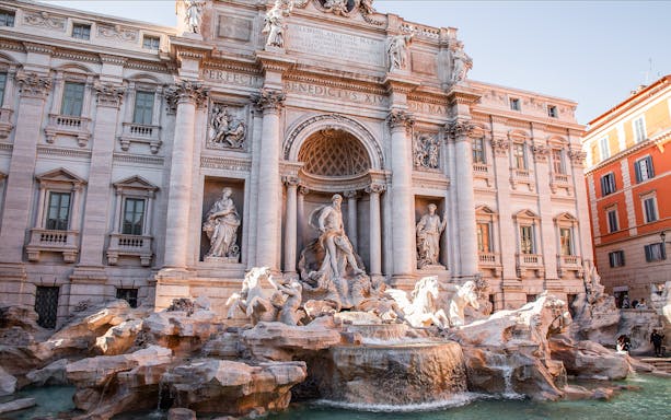 Trevi Fountain in Rome with intricate sculptures and flowing water.