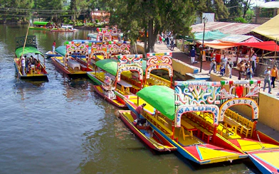 Colorful trajineras at Xochimilco boarding point, Mexico City.