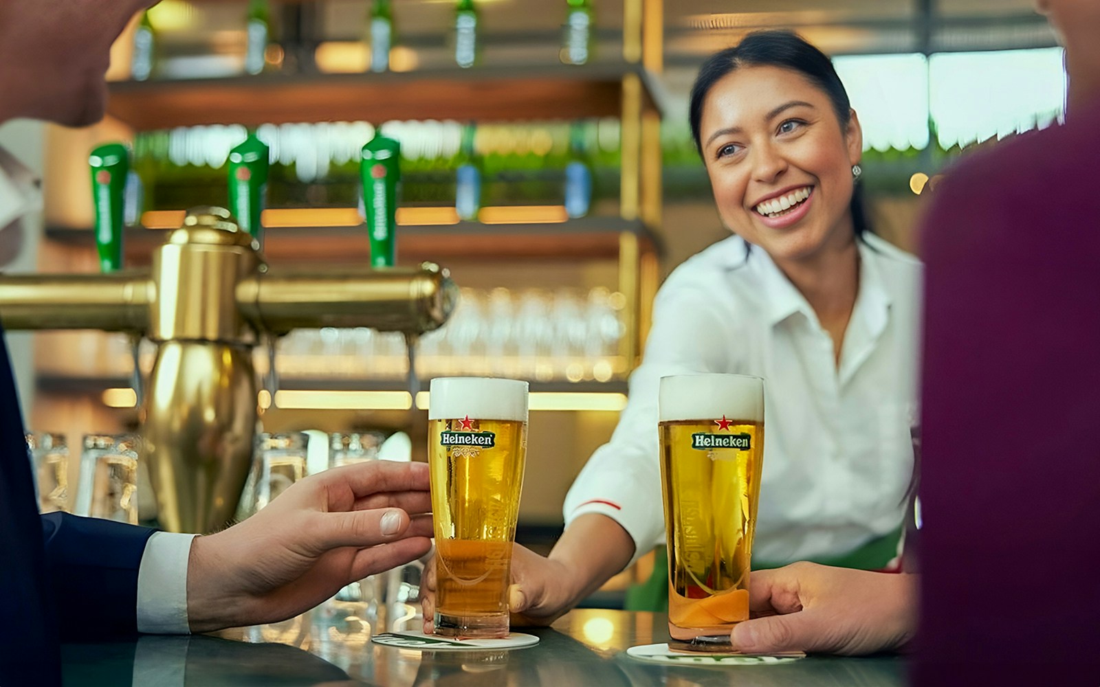 Bartender serving Heineken beers at the Heineken Experience in Amsterdam.