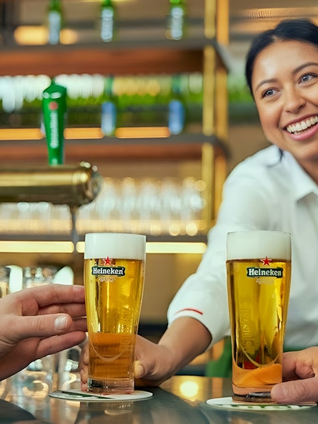 Bartender serving Heineken beers at the Heineken Experience in Amsterdam.