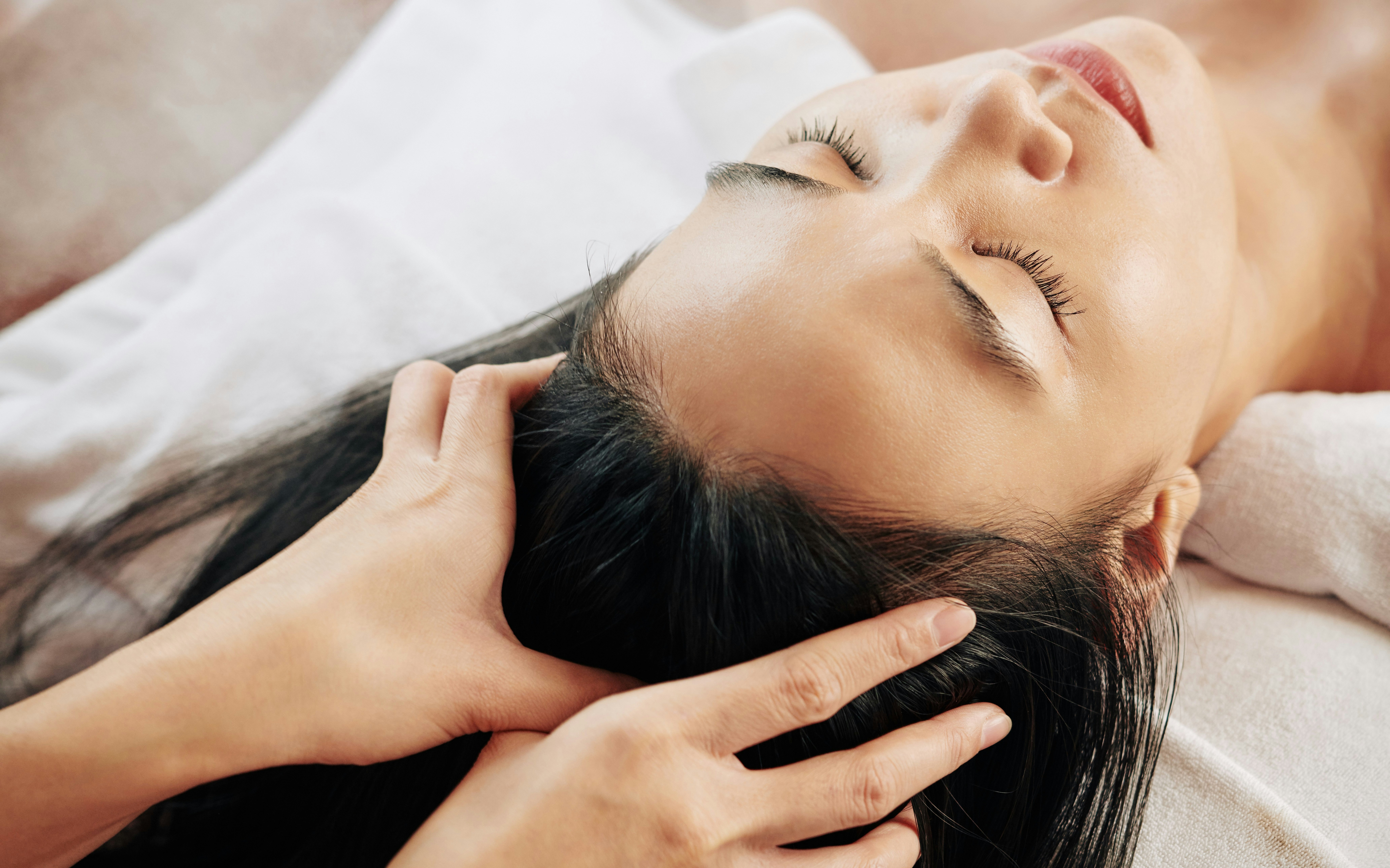 Head massage at a spa, focusing on relaxation and wellness.