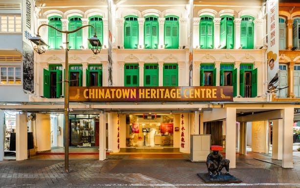 Chinatown Heritage Centre entrance with green shutters and street view.