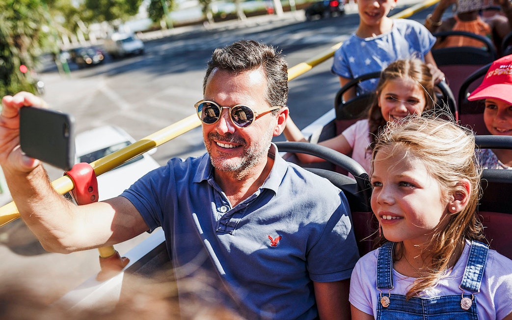 Group enjoying open-top bus ride from Messina to Taormina.