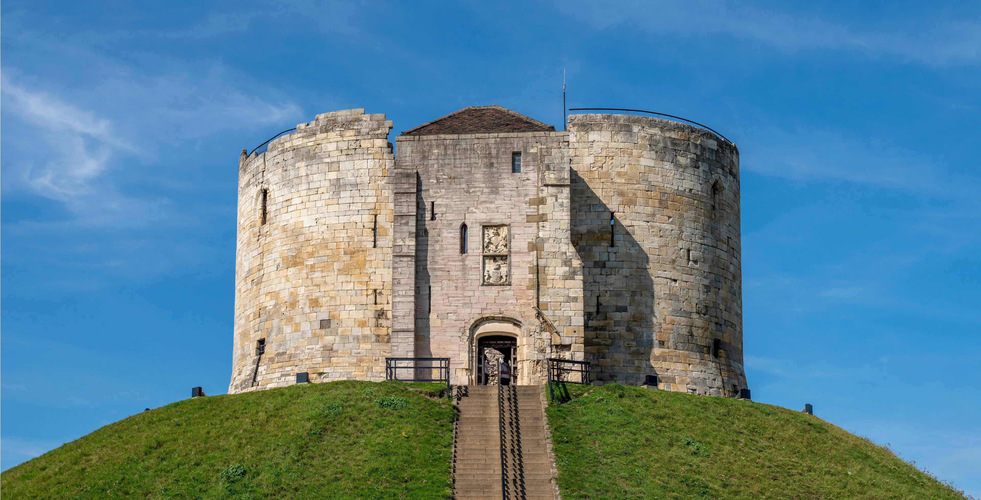 Clifford's Tower, historic Norman castle on a grassy mound in York, England.