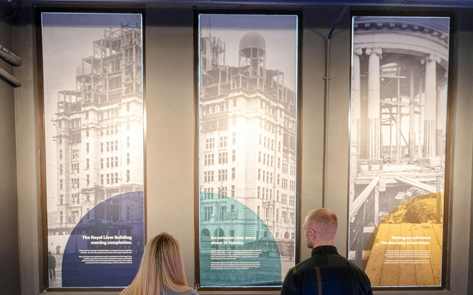 Guests viewing historical panels inside the Royal Liver Building.