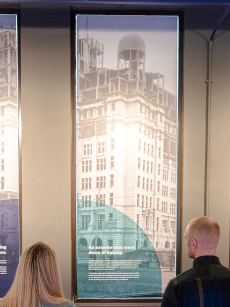 Guests viewing historical panels inside the Royal Liver Building.