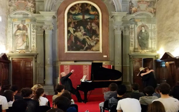 Opera singer performing at a grand piano in a historic Florence venue during an Opera Arias Concert.
