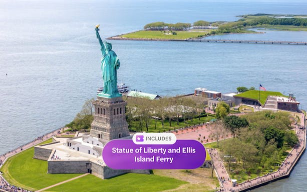 Statue of Liberty on Liberty Island with Ellis Island ferry in New York Harbor.