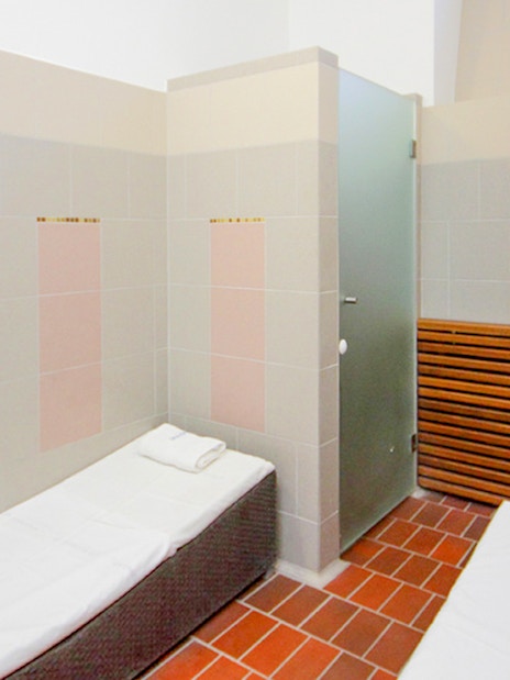 Private cabin interior at Lukacs Spa with beds and a sink.