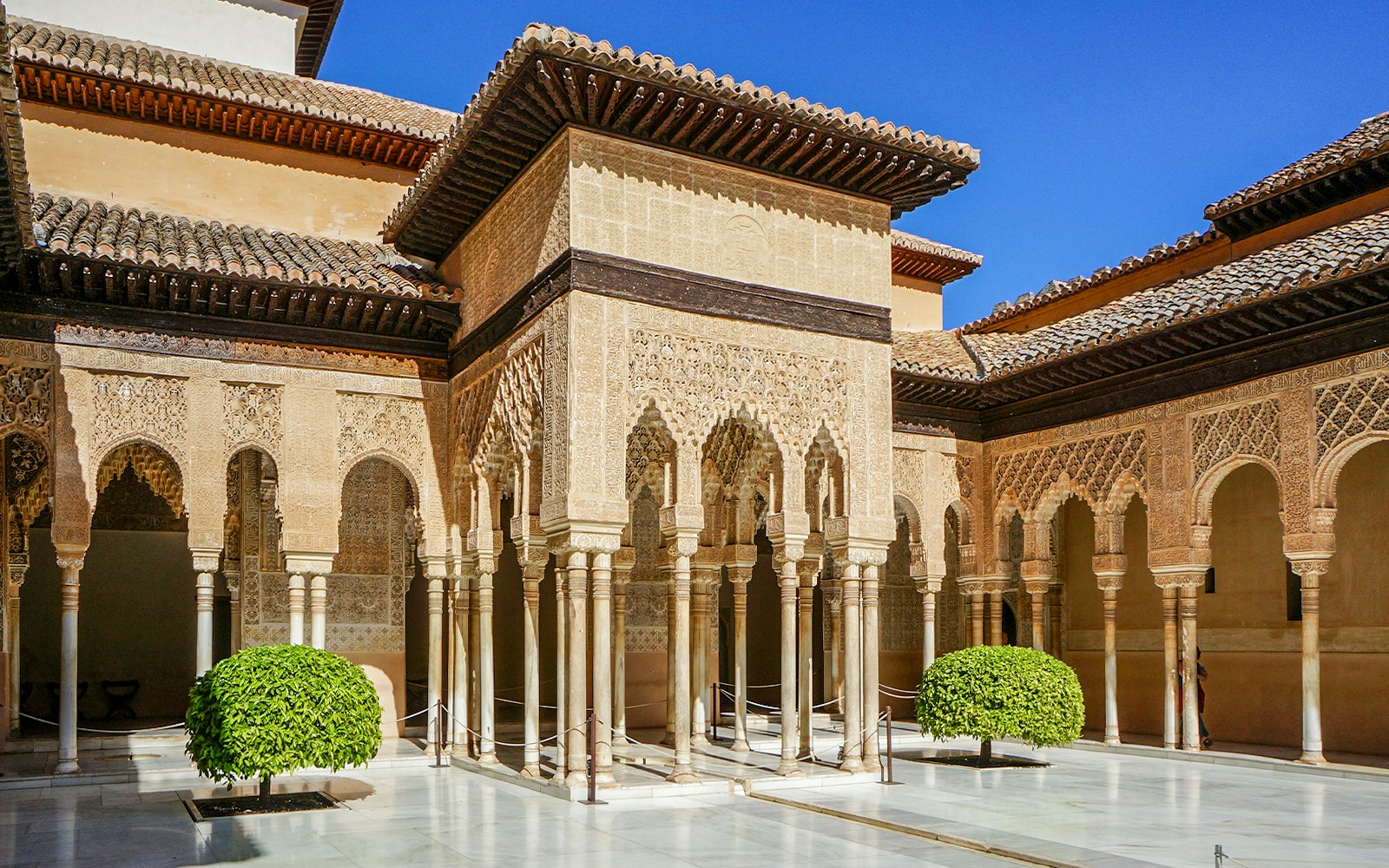 Alhambra's Nasrid Palaces courtyard with intricate arches and columns, Granada, Spain.