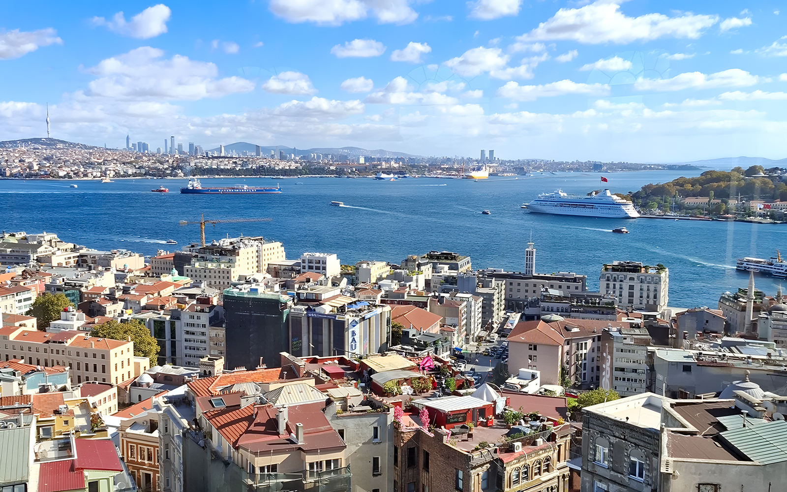View of Istanbul skyline and Bosphorus from Galata Tower, with ships and cityscape.