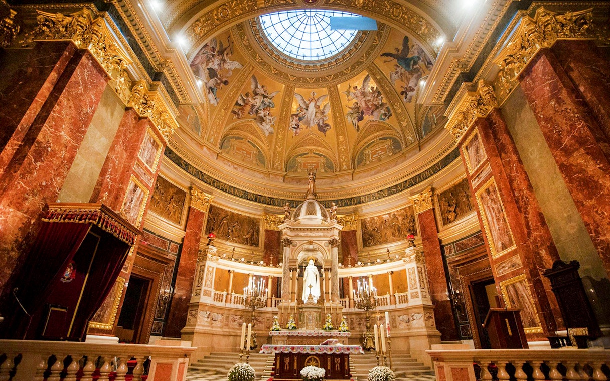 Interior view of St. Stephen's Basilica in Budapest, showcasing ornate dome and altar.