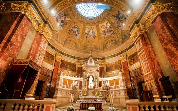 Interior view of St. Stephen's Basilica in Budapest, showcasing ornate dome and altar.