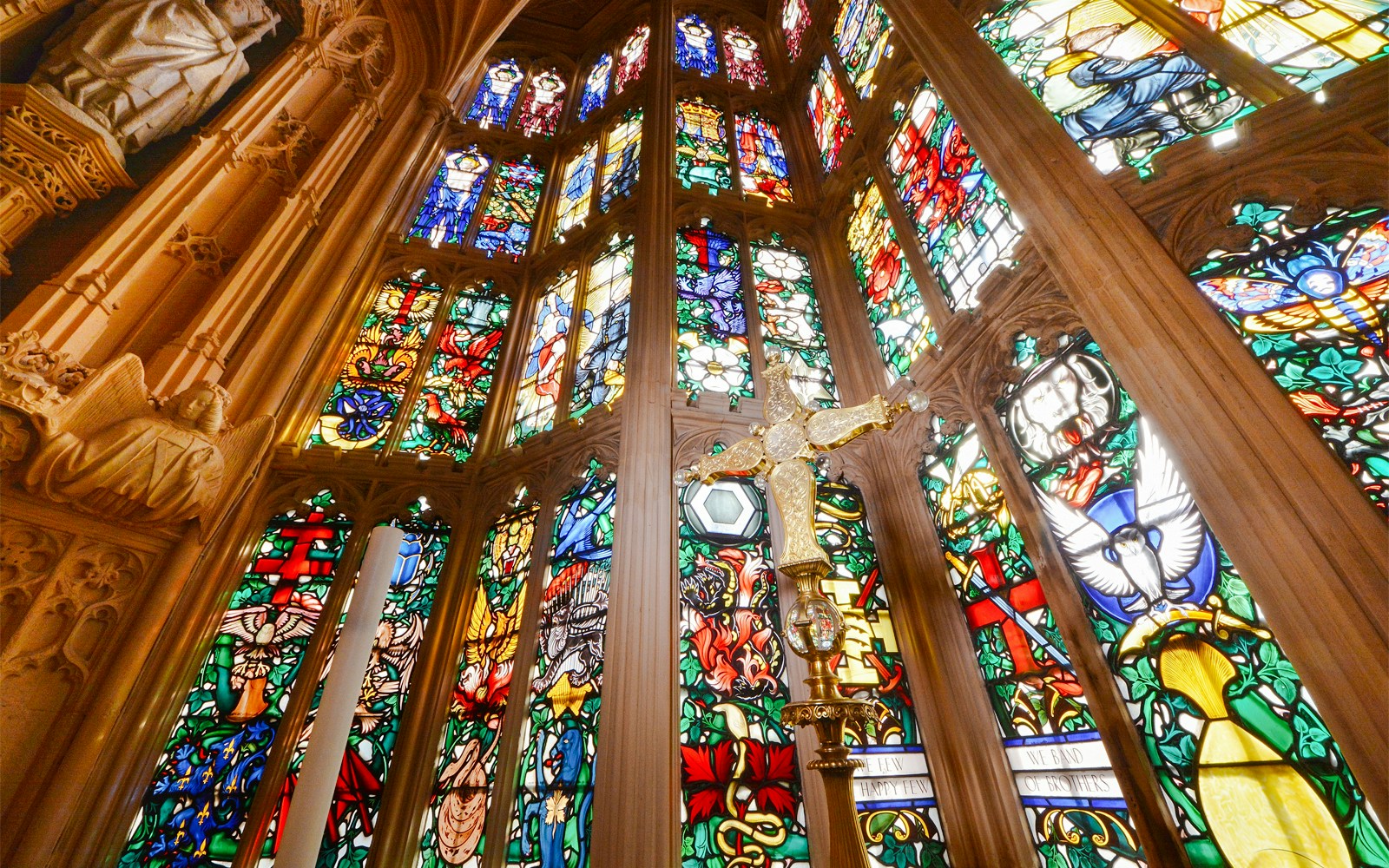 Stained glass windows and ornate carvings inside Westminster Abbey.