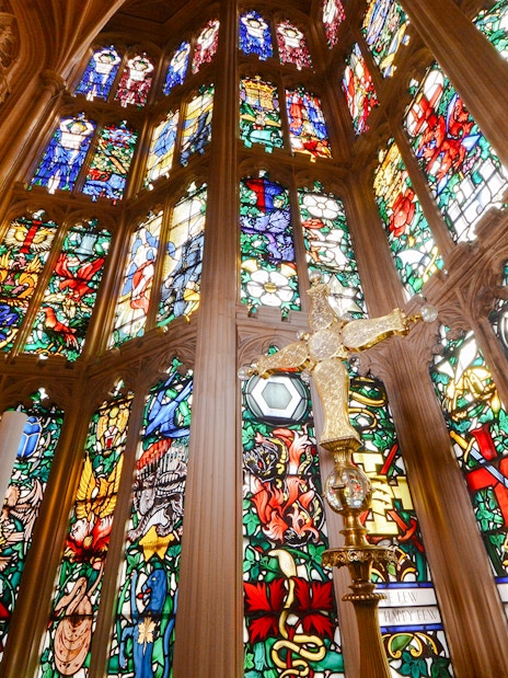 Stained glass windows and ornate carvings inside Westminster Abbey.
