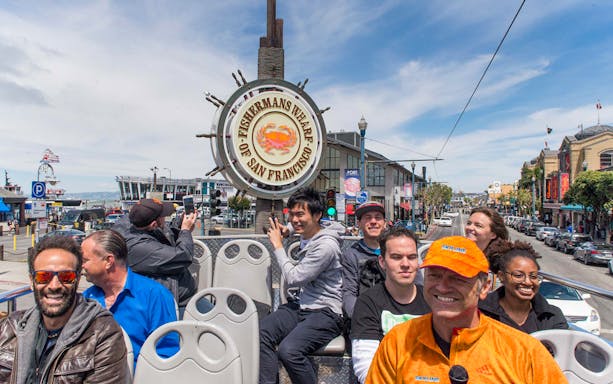 Tourists on an open-top bus at Fisherman's Wharf, San Francisco, during a Hop-On Hop-Off City Day Tour.