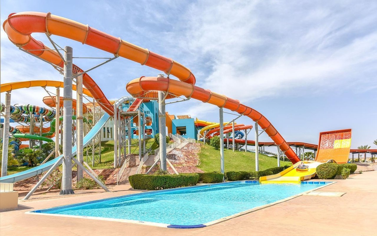 Water slides at Makadi Water World, Hurghada, with a pool in the foreground.