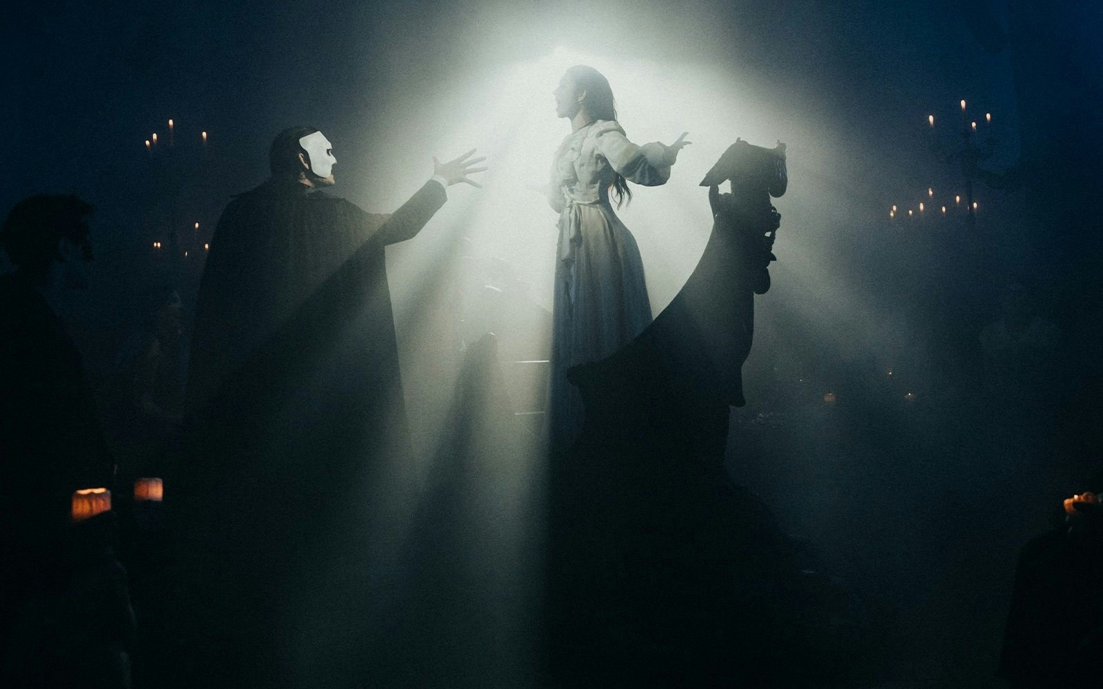 Masquerade Broadway stage performance with actors in dramatic lighting.