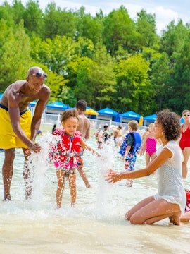 Children playing in wave pool at Hurricane Harbor, Six Flags New Jersey.