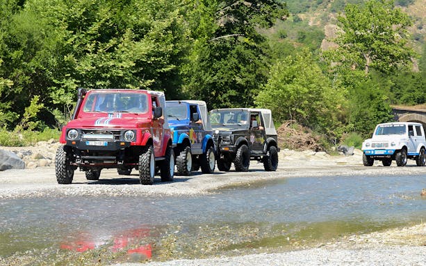 4x4 vehicles driving through Valle Alcantara on a Samurai off-road tour.