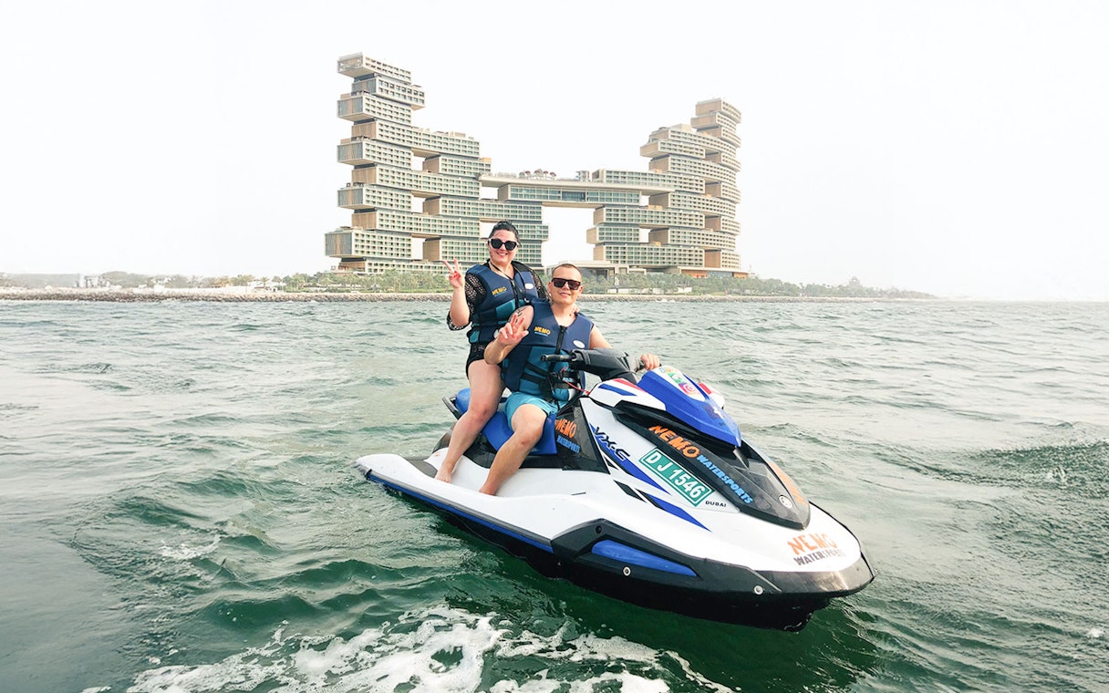 Tourists on jet ski near Atlantis The Royal, Dubai.