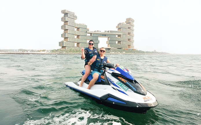 Tourists on jet ski near Atlantis The Royal, Dubai.