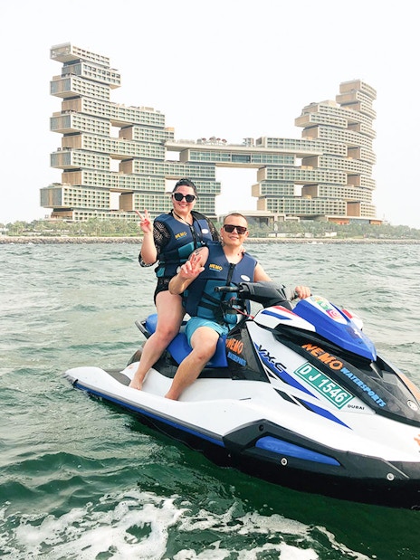 Tourists on jet ski near Atlantis The Royal, Dubai.