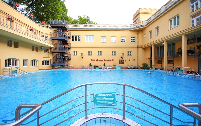 Lukacs Spa outdoor pool with historic building in Budapest, Hungary.