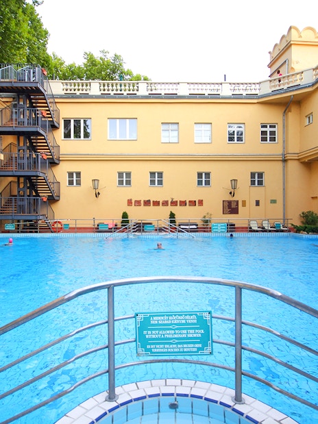 Lukacs Spa outdoor pool with historic building in Budapest, Hungary.