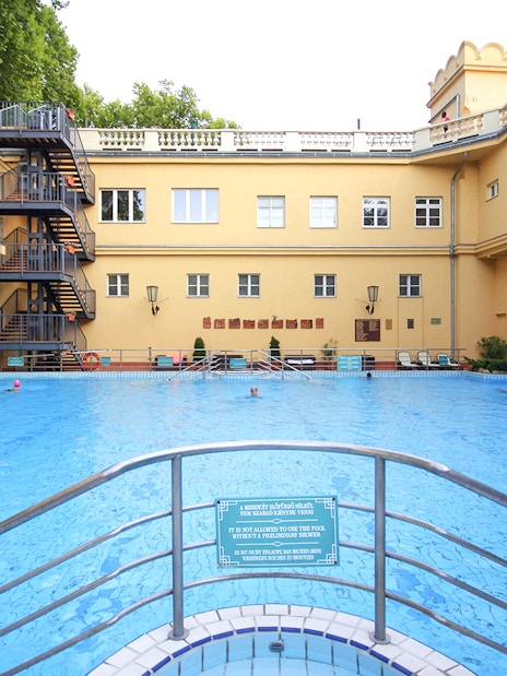 Lukacs Spa outdoor pool with historic building in Budapest, Hungary.
