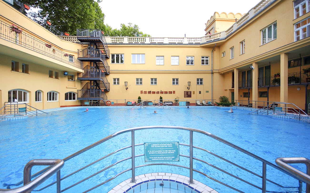Lukacs Spa outdoor pool with historic building in Budapest, Hungary.