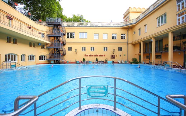 Lukacs Spa outdoor pool with historic building in Budapest, Hungary.